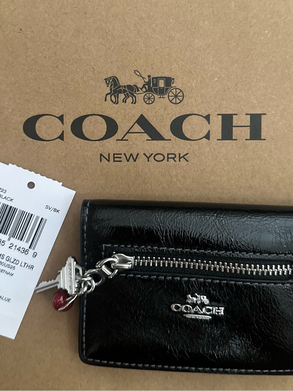 Coach Black Glazed Leather Zip Card Holder with Silver Hardware and Red Charm